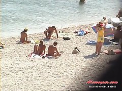 After spying for half an hour on that nude beach I had finally found a really beautiful girl voyeur video #1