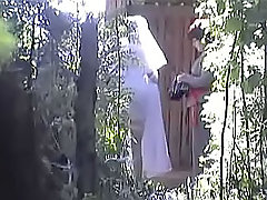 Well-bodied brunette in short skirt decided that she was absolutely alone behind that huge tree, so she took off her pants and began to pee voyeur video #1